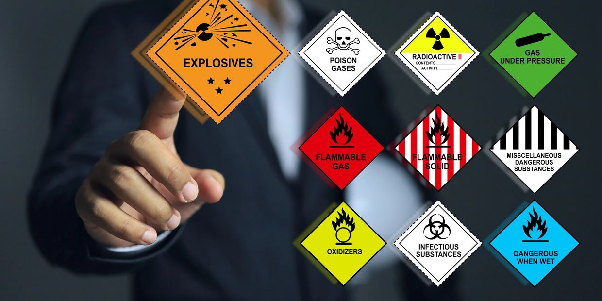 Supervisor or leader pointing to the explosives symbols and all type of the various types of dangerous goods involved. (Supervisor or leader pointing to the explosives symbols and all type of the various types of dangerous goods involved., ASCII, 119